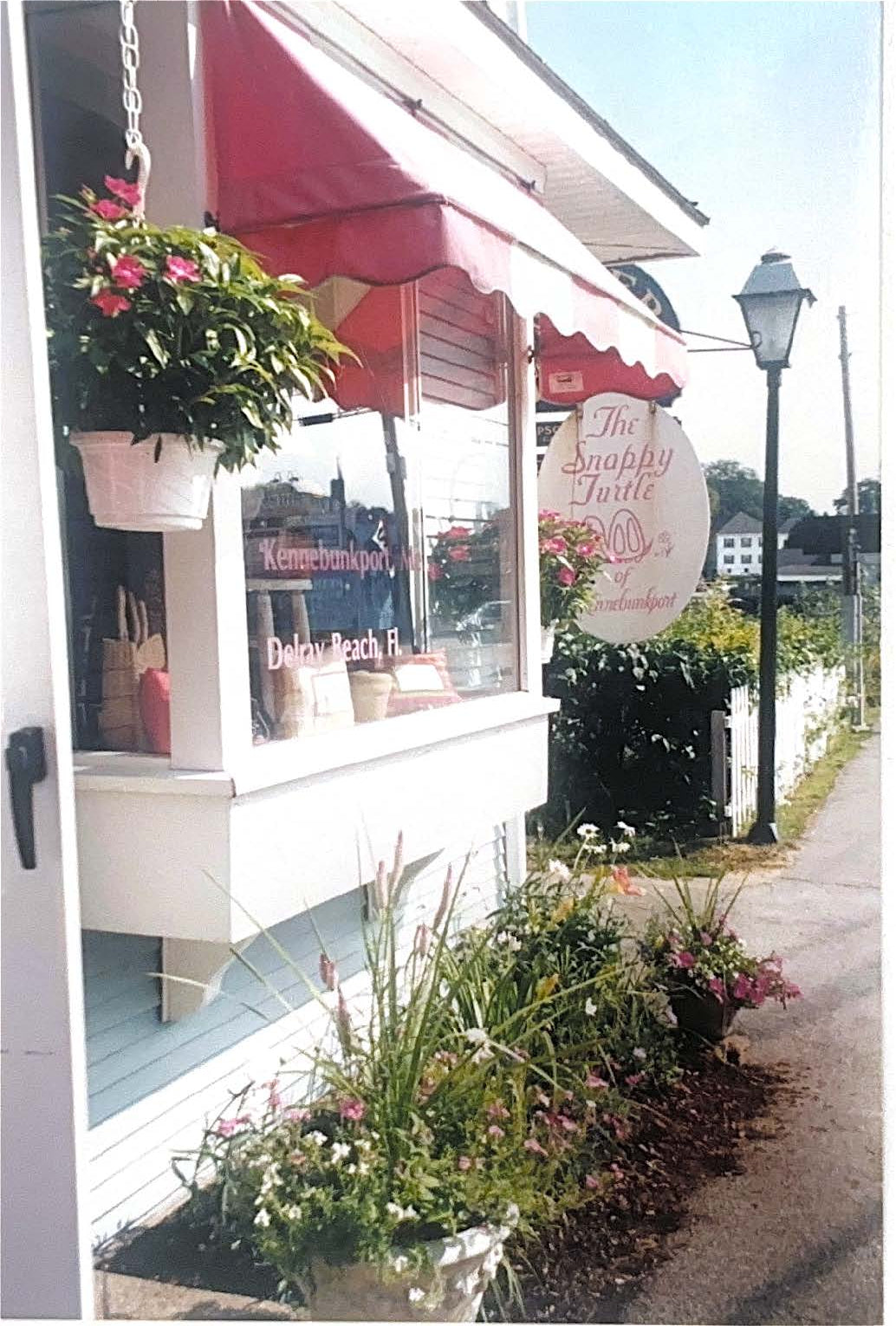 Floral arrangements in front of a store with a sign in the background